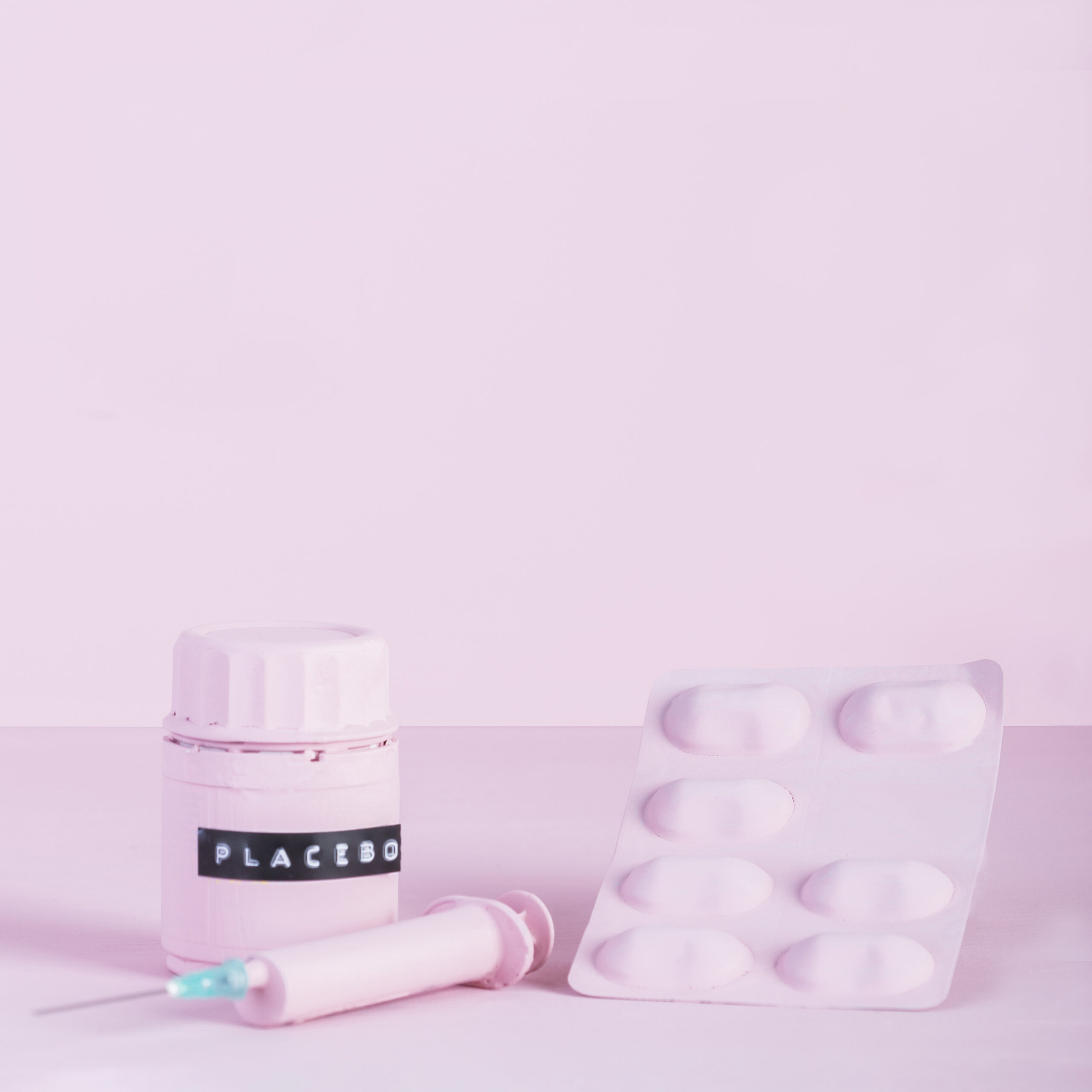 syringe-pill-blister-placebo-bottle-pink-background